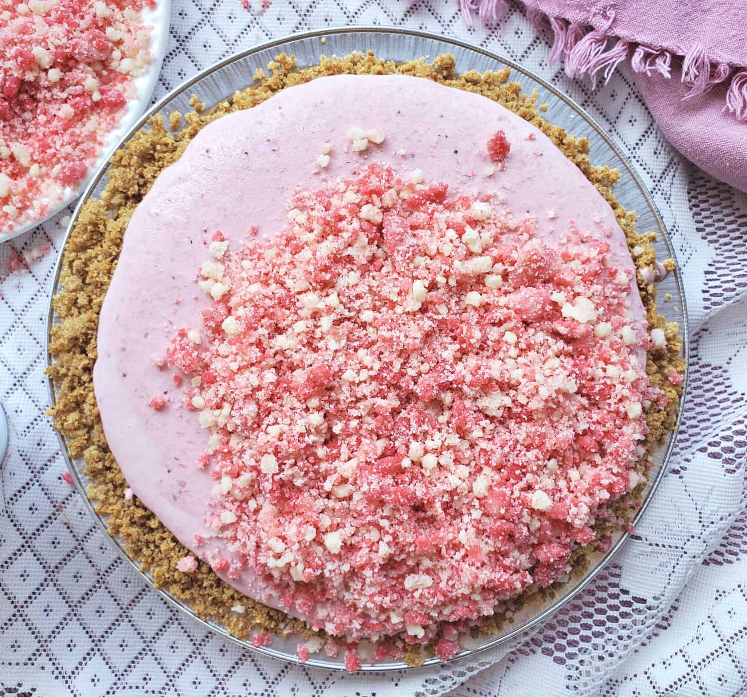 Strawberry Shortcake Freezer Pie: Homemade strawberry ice cream pie without any churning, and a pink punch of strawberry shortcake crumbles. Summer is getting tasty!